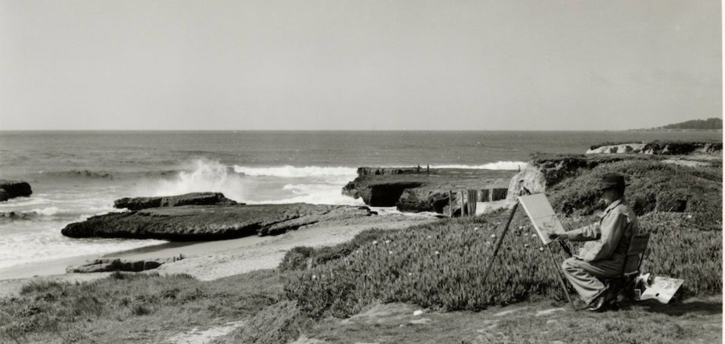 Archival black and white photograph of the Pleasure Point coastline with an artist at an easel